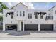 Modern townhomes feature multiple garage doors, black awnings, and a terracotta roof at 3210 W Horatio St # 9, Tampa, FL 33609