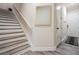 Bright foyer features a stairway with wood steps and a gray wood floor at 3210 W Horatio St # 9, Tampa, FL 33609