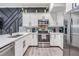 Modern kitchen featuring a white quartz countertop, stainless steel appliances, and a mosaic backsplash at 3210 W Horatio St # 9, Tampa, FL 33609