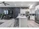Open kitchen with a large island, stainless steel appliances and a decorative accent wall at 3210 W Horatio St # 9, Tampa, FL 33609
