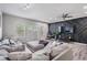 Bright living room with modern panel wall, ceiling fan, and a comfortable sectional sofa at 3210 W Horatio St # 9, Tampa, FL 33609