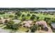 Aerial view of homes, a golf course and lake in the Lake Jovita community at 33744 Americana Ave, Dade City, FL 33525