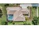 Aerial view of a single-Gathering home with a screened pool and manicured landscaping at 33744 Americana Ave, Dade City, FL 33525