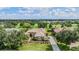 Stunning aerial view of house featuring lush green landscaping, tile roof, and picturesque golf course surroundings at 33744 Americana Ave, Dade City, FL 33525