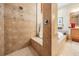 Spacious bathroom with tiled shower and tub, decorative accents, and wood vanity at 33744 Americana Ave, Dade City, FL 33525