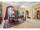 Formal dining room boasts elegant chandelier, neutral walls, and large windows, perfect for entertaining guests at 33744 Americana Ave, Dade City, FL 33525