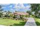 Beautiful landscaped yard and driveway leading to a single-Gathering home at 33744 Americana Ave, Dade City, FL 33525