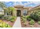 Stunning home entrance with stone accents, mature landscaping and beautiful double door entry at 33744 Americana Ave, Dade City, FL 33525