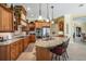 Spacious kitchen featuring custom cabinets, granite counters, stainless appliances, and a center island at 33744 Americana Ave, Dade City, FL 33525