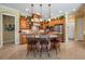 Bright eat-in kitchen with granite countertops, island, stainless steel appliances and wooden cabinetry at 33744 Americana Ave, Dade City, FL 33525