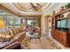 Bright living room with tile flooring, a ceiling fan, and a glass door leading to the outside at 33744 Americana Ave, Dade City, FL 33525