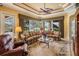 Living room area with comfortable seating, ceiling fan, and access to outdoor pool area at 33744 Americana Ave, Dade City, FL 33525