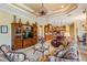 Bright living room featuring a large cabinet, seating, and kitchen area with natural light at 33744 Americana Ave, Dade City, FL 33525