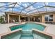Stunning in-ground pool and spa area with covered lanai, perfect for entertaining at 33744 Americana Ave, Dade City, FL 33525