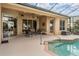 Covered patio with a pool and a sitting area with outdoor furniture at 33744 Americana Ave, Dade City, FL 33525