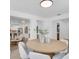 Dining room featuring a large wooden table with light-colored chairs at 3381 19Th Sw Pl, Largo, FL 33774
