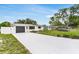 Beautiful single-story home showcasing a long driveway, attached garage, and manicured landscaping at 3381 19Th Sw Pl, Largo, FL 33774
