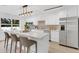 Modern kitchen with stainless steel appliances and eat-in island with seating at 3381 19Th Sw Pl, Largo, FL 33774