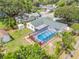 This aerial view shows a private pool in a fenced backyard in a neighborhood with lots of trees at 3502 King Richard Ct, Seffner, FL 33584