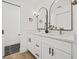 Bathroom featuring double vanity with white cabinets, modern fixtures, and tile floors at 3502 King Richard Ct, Seffner, FL 33584