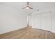 Bedroom with wood-look floors, closet, and fan at 3502 King Richard Ct, Seffner, FL 33584