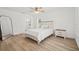 Bedroom featuring wood-look flooring, neutral decor, and a view to the ensuite bathroom at 3502 King Richard Ct, Seffner, FL 33584