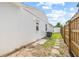Exterior of a home showing the side yard with partial views of the yard, fence, and exterior walls at 3502 King Richard Ct, Seffner, FL 33584