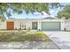 Inviting single-story home with an attached garage, and a well-maintained front yard at 3502 King Richard Ct, Seffner, FL 33584