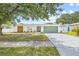 Charming single-story home with an attached garage, and a well-maintained front yard at 3502 King Richard Ct, Seffner, FL 33584