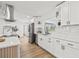 Stylish kitchen with stainless steel appliances, hardwood floors, and ample lighting at 3502 King Richard Ct, Seffner, FL 33584
