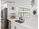 Kitchen featuring stainless steel appliances, light countertops, and a view to the pool outside the window at 3502 King Richard Ct, Seffner, FL 33584