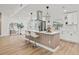 Kitchen island with seating, modern pendants, and stainless steel appliances at 3502 King Richard Ct, Seffner, FL 33584