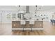 Kitchen island with seating, stylish pendants, and stainless steel appliances at 3502 King Richard Ct, Seffner, FL 33584