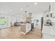 Open concept kitchen featuring an island, stainless steel appliances, and view to the living area at 3502 King Richard Ct, Seffner, FL 33584