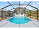 A refreshing screened-in pool invites relaxation under the sunlit, clear sky at 3502 King Richard Ct, Seffner, FL 33584