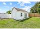 Exterior view of a charming white shed featuring a shingled roof, window, and sliding glass door at 3502 King Richard Ct, Seffner, FL 33584