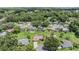 Aerial view of homes with pools in a lush green neighborhood at 37147 Foxrun Pl, Zephyrhills, FL 33542