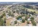 Vast aerial view featuring a home with a private pool in a community surrounded by lush greenery and mature trees at 37147 Foxrun Pl, Zephyrhills, FL 33542