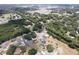 Gorgeous aerial shot of a neighborhood highlighting a home with a private pool surrounded by trees and green spaces at 37147 Foxrun Pl, Zephyrhills, FL 33542