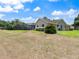 Expansive backyard featuring a screened-in pool area and lush greenery, perfect for outdoor entertaining at 37147 Foxrun Pl, Zephyrhills, FL 33542