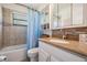 Bathroom featuring a tub/shower combo, white vanity with mosaic tile backsplash, and mirrored medicine cabinet at 37147 Foxrun Pl, Zephyrhills, FL 33542