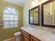Well-lit bathroom with double sinks, a decorative mirror, and modern fixtures, creating a spa-like retreat at 37147 Foxrun Pl, Zephyrhills, FL 33542