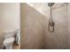 Bathroom featuring a tiled walk-in shower with modern fixtures and nearby toilet at 37147 Foxrun Pl, Zephyrhills, FL 33542