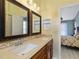 Elegant bathroom featuring double sinks and views of a bedroom, creating a harmonious and inviting atmosphere at 37147 Foxrun Pl, Zephyrhills, FL 33542