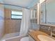 Bathroom with a bathtub, tiled walls and a shower curtain, vanity, and granite countertops at 37147 Foxrun Pl, Zephyrhills, FL 33542
