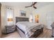 Cozy bedroom featuring a neutral color palette, ceiling fan, and an ensuite bathroom for added convenience at 37147 Foxrun Pl, Zephyrhills, FL 33542