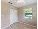Bedroom has wood-look floors, a ceiling fan, and a large window for ample natural light at 37147 Foxrun Pl, Zephyrhills, FL 33542