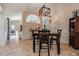 Dining room area features a chandelier, dining table, and a view into the living room, enhancing the open layout at 37147 Foxrun Pl, Zephyrhills, FL 33542