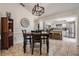 Dining room with view into kitchen, stylish decor, and pendant lighting at 37147 Foxrun Pl, Zephyrhills, FL 33542