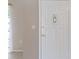Interior view of the entryway with a white paneled door and decorative glass insert at 37147 Foxrun Pl, Zephyrhills, FL 33542